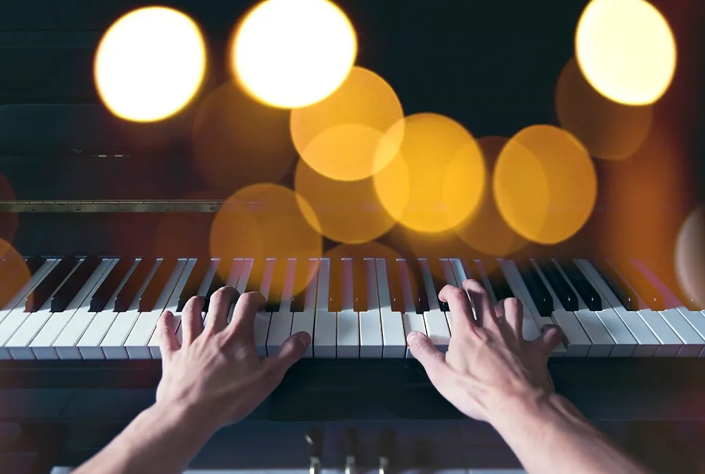 Hands playing piano keys